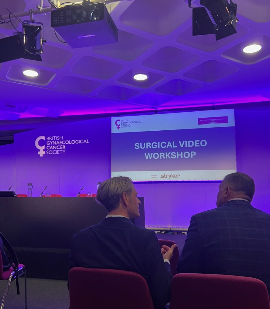 Photograph of cancer research surgical video workshop powerpoint screen in a conference room