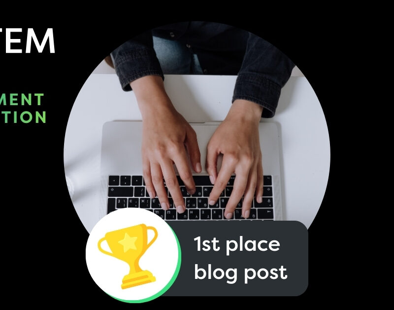 Graphic with In2STEM logo saying public engagement competition, a stock image of hands typing on a keyboard, and a trophy graphic below, with the text 1st place blog post along the bottom