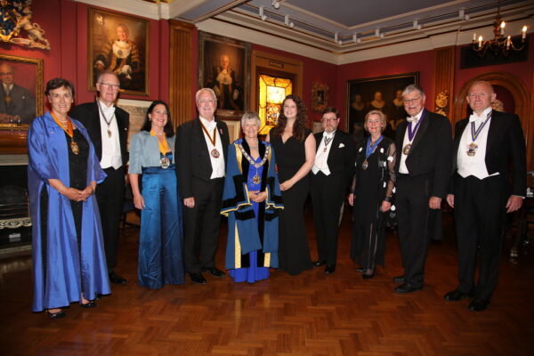 Photograph of attendees at the Worshipful Company of Scientific Instrument Makers' annual banquet, including In2scienceUK staff member Rebecca Jelbert with the WCSIM Master in the centre